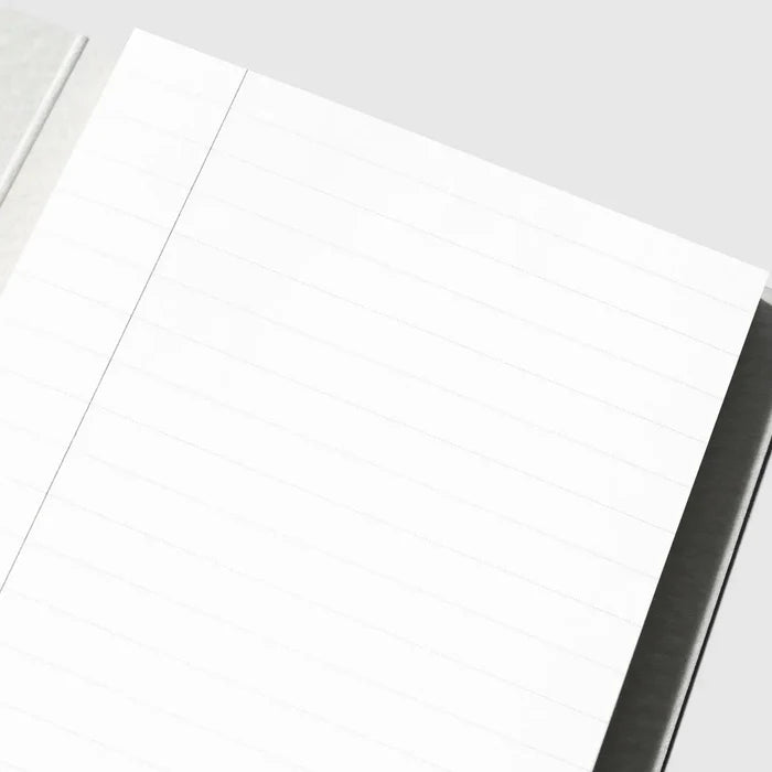 A close-up of a white lined notepad or notebook page with a single vertical ruling, photographed on a light gray background.