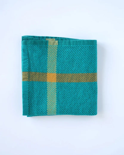 Teal fabric with gold cross pattern on a white background