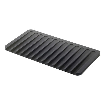 A dark gray rectangular mat with parallel raised ridges, shown at an angle on a plain white background.