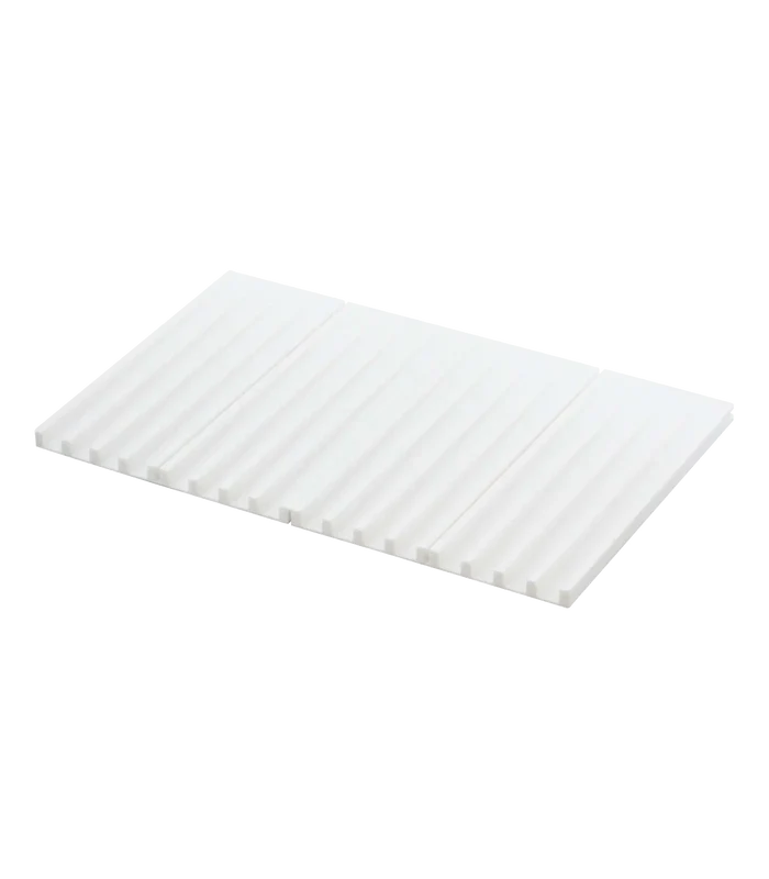 A white rectangular corrugated silicone drying mat with a ribbed surface, shown at an angle on a plain white background.