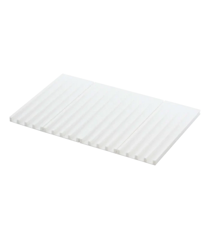 A white rectangular corrugated silicone drying mat with a ribbed surface, shown at an angle on a plain white background.