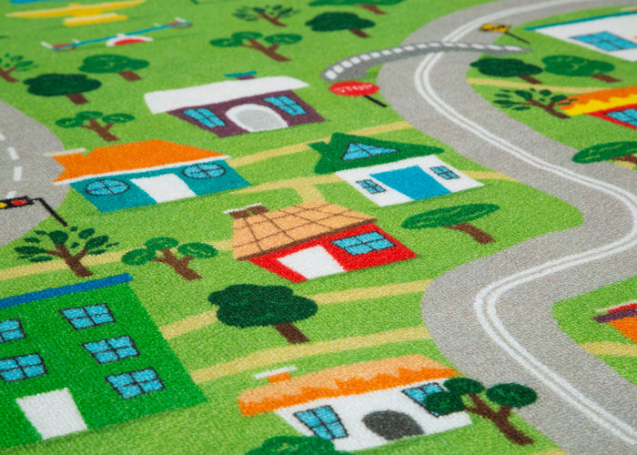 Children's play rug with a town layout featuring houses, roads, and trees.