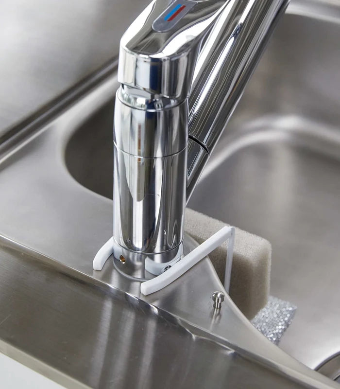 Chrome kitchen faucet on a stainless steel sink