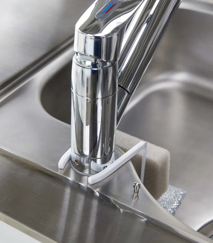 Chrome kitchen faucet on a stainless steel sink