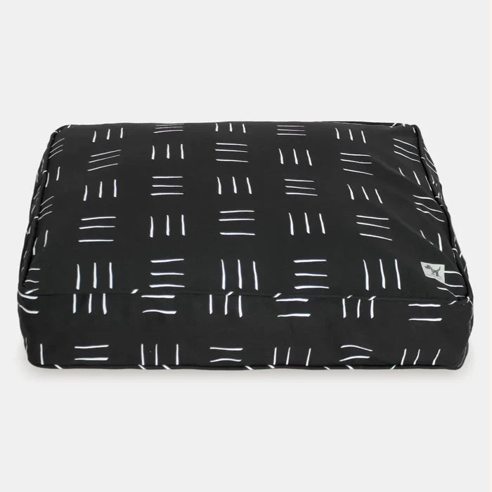 Black pet bed with white line pattern on a white background