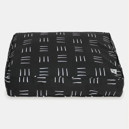 Black pet bed with white line pattern on a white background