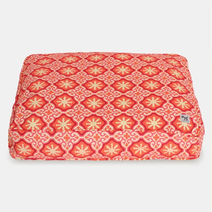 Red and yellow patterned pet bed on a white background