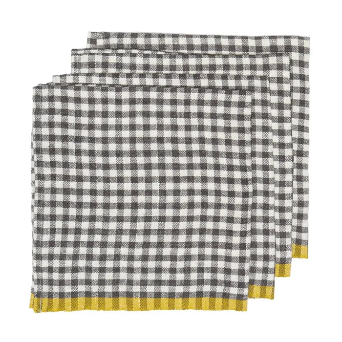 Three folded checkered napkins with a black and white gingham pattern and a yellow striped border, arranged in a stack on a white background.