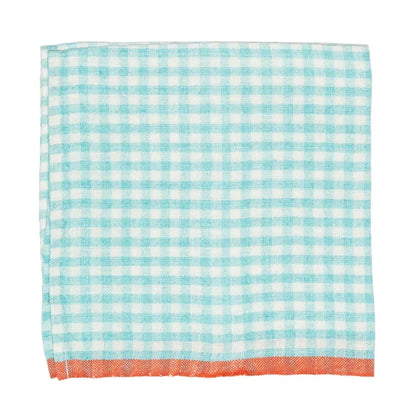 A square napkin with a light blue gingham check pattern and a solid orange-red fringed border.