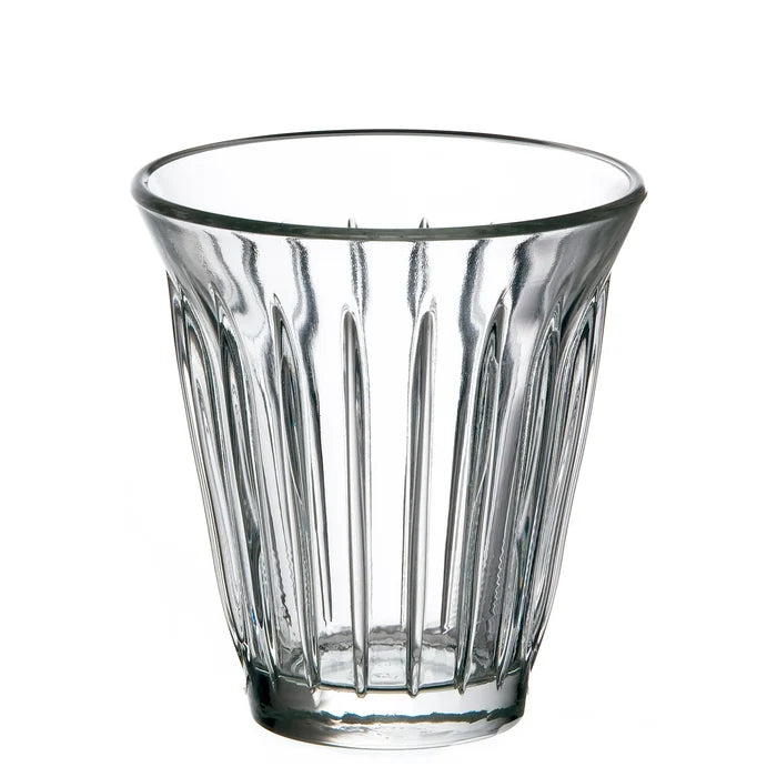 Clear glass tumbler with vertical ridges on a white background